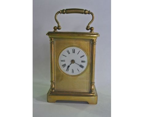 A French carriage clock, the brass case with circular enamelled dial and eight day timepiece