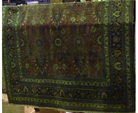 A Persian style wool carpet with red field, stylised floral detail, set within geometric running borders