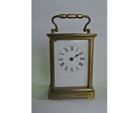 A French carriage clock with brass casework, enamel dial and eight day timepiece