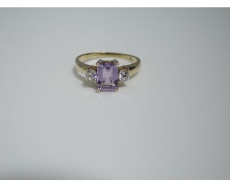 A ring, centred with rectangular stepped-cut lilac stone, flanked with two cubic zirconia, in 9ct gold, size M 1/2