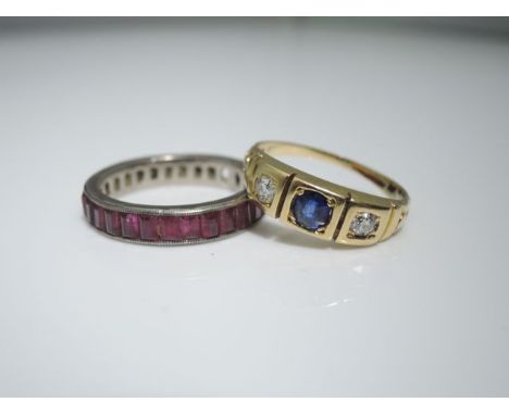 A late Victorian sapphire and diamond ring, centred with an oval mixed-cut sapphire weighing approximately 0,25cts, flanked w