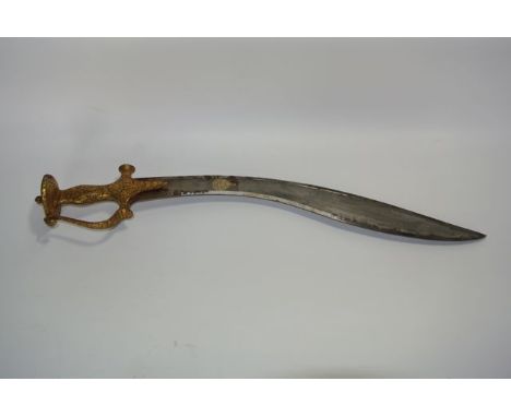 A 19th century Eastern sword of curved form, the handle and handguard with decorative extensive gold coloured chased floral d