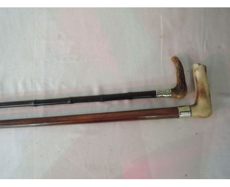 A slender bamboo walking cane with worked antler handle united within a foliate embossed white metal collar together with a f