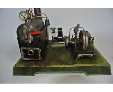 An early 20th century German tin plate and live steam model industrial engine  with brick modelled chimney driving a horizont