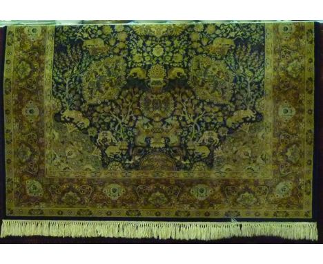 A Persian style wool carpet with multi-floral detail upon a blue ground within running borders
