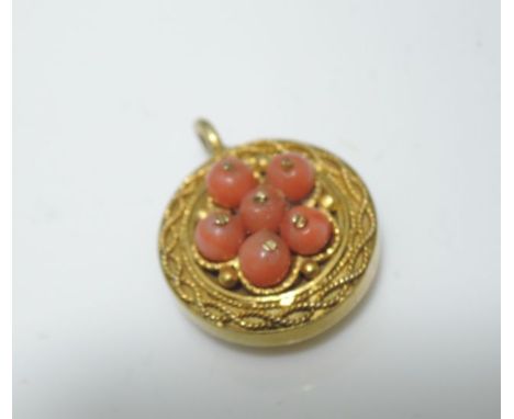 A Victorian clasp of circular form centred with a cluster of six coral beads, in unmarked 18ct gold PLEASE NOTE ONE BEAD IS M