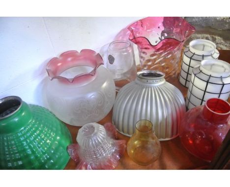 A large collection of mostly ceiling light shades to include numerous milk glass/opaque examples, three others with cranberry