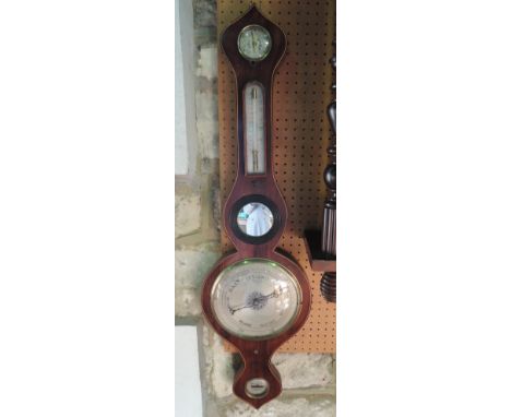 A Georgian mahogany wheel barometer with boxwood and ebony string banded border and silvered dial