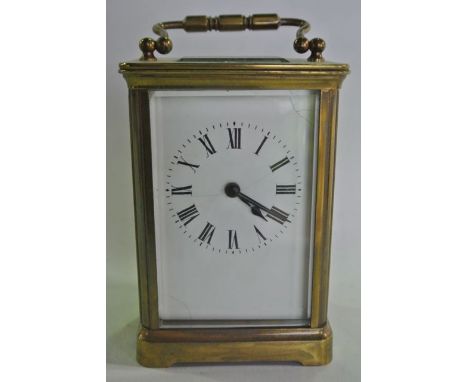 A brass carriage clock with eight day timepiece