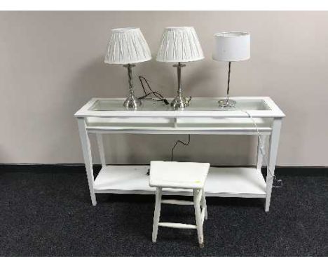 An Ikea console table and three table lamps 