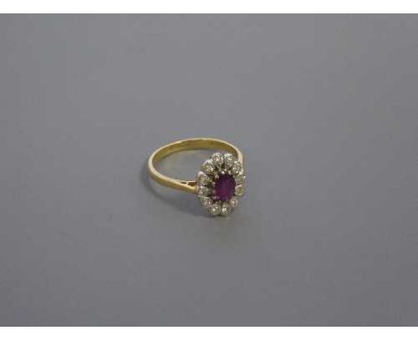 An 18ct gold ruby and diamond cluster ring, size N-O, 4.1g.