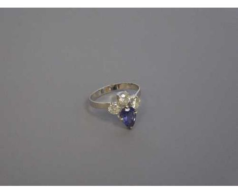 A pear-cut tanzanite and three stone diamond ring