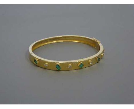 A 9ct gold emerald and diamond bangle, 19.2g