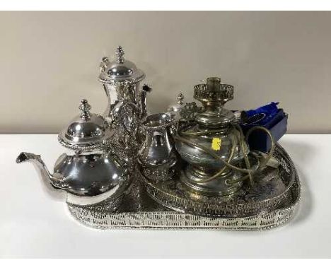 Two plated gallery trays containing a four piece plated Viners tea service, napkin rings, oil lamp etc