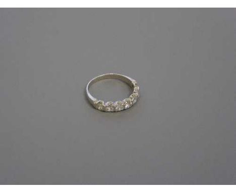 An 18ct white gold seven stone diamond half eternity ring, 2.7g, size M.