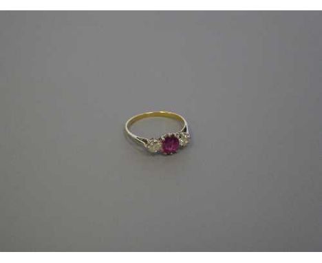 An 18ct gold three stone diamond and ruby ring