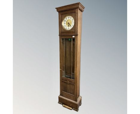 A continental oak longcase clock with silvered and brass dial, pendulum and weights 