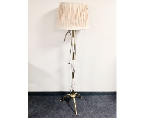 A brass and porcelain standard lamp with shade 