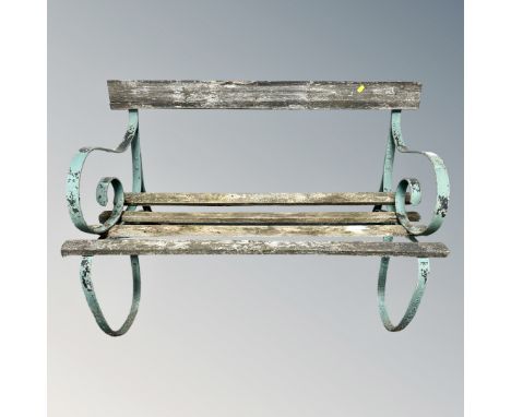 A wrought metal and teak garden bench 