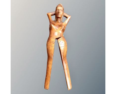 A carved wooden nut cracker in the form of a woman, length 33 cm 