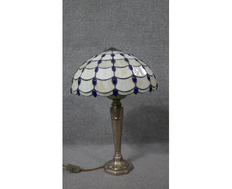 A Tiffany style coloured stained glass lace design table lamp with gilt metal foliate design base. (Screw in finial missing) 