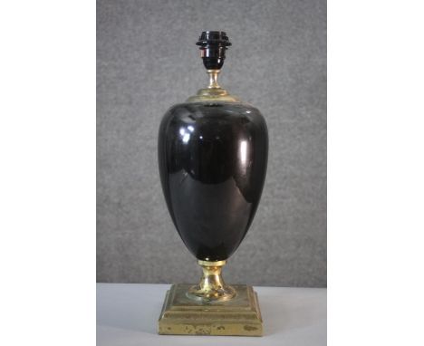 A black enamel and brass urn design lamp on square stepped base. H.46 W.16 cm. 