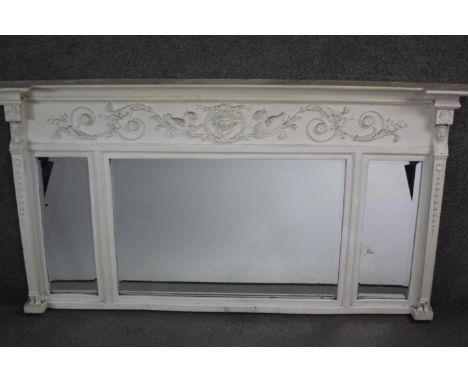 A 19th century overmantel mirror, later painted with mask and ribbon relief frieze above triple plates flanked by Classical s