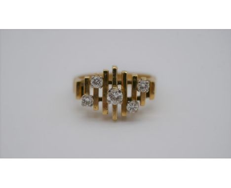 A mid century Brutalist design 18 carat yellow gold ring. Set with five round brilliant cut diamonds with a combined approxim