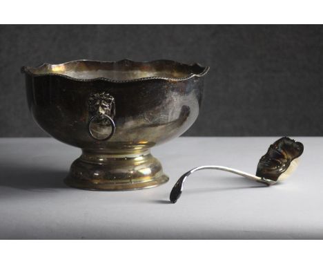 A Victorian silver plated pedestal punch bowl with lion head handles and foliate design repousse ladle. H.19 Dia.32 cm. 