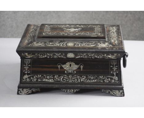 A 19th century Coromandel and mother of pearl inlaid sarcophagus sewing box with paper lined lift out tray with compartments.