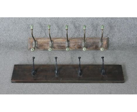 Two wall mounted coat racks. One with cast iron hooks and one with green ceramic and brass textured hooks. H.14 W.76 D.11cm 