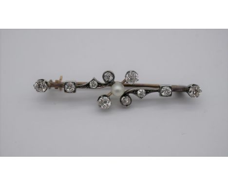 A Victorian yellow and white metal (tests as 9ct and silver) foliate design diamond and pearl bar brooch. Set to centre with 