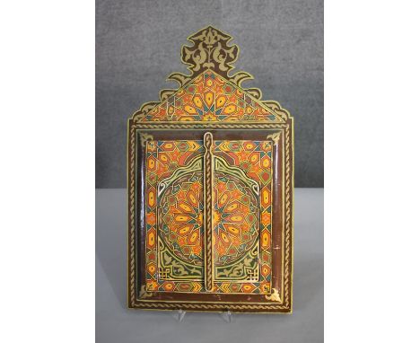 An Indian lacquered and hand painted mirror with opening doors. Decorated with a stylised floral design. H.60 W.34cm. 