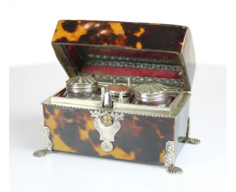 A fine Tortoiseshell travelling writing set of trunk form on 4 silver mounted feet opening to revel a full set comprising Ink