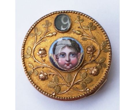 18ct Gold box inlaid with Mother of Pearl decorated with small enamel portrait. Hinged base opens and top revolves displaying