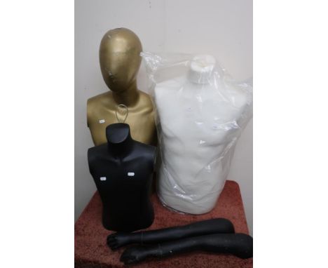 Gold painted male torso mannequin and two other torso mannequins 