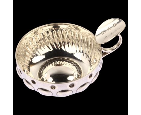 A French silver wine taster, with relief embossed decoration, indistinct maker's mark, bowl diameter 8cm, 3.5ozNo damage or r