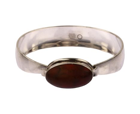 NIELS ERIK FROM - a mid-20th century Danish modernist sterling silver and Baltic amber torque bangle, set with oval cabochon 