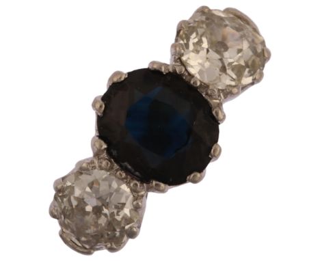 A late 20th century 18ct gold three stone sapphire and diamond ring, prong set with 1.25ct oval mixed-cut sapphire and old-cu