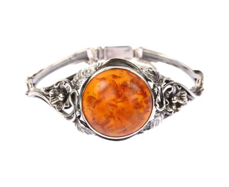 EINER FEHRN - an Art Nouveau Danish sterling silver and Baltic amber bracelet, with openwork floral shoulders, setting height