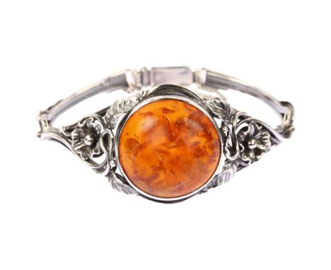 EINER FEHRN - an Art Nouveau Danish sterling silver and Baltic amber bracelet, with openwork floral shoulders, setting height