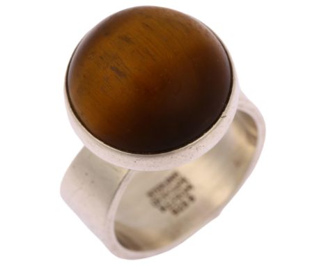 NIELS ERIK FROM - a mid-20th century Danish modernist sterling silver tigers eye ring, set with round cabochon tigers eye, se