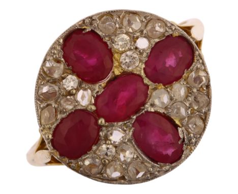 A late 20th century ruby and diamond circular cluster ring, unmarked 18ct gold settings with oval mixed-cut ruby cross inter-