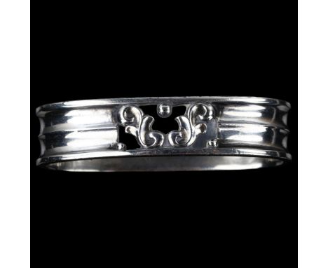 GEORG JENSEN and WENDEL - an Art Deco Danish sterling silver oval napkin ring, with pierced foliate decoration, model no. 110