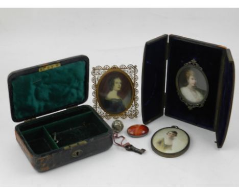 A cased Edwardian oval miniature portrait of an elegant lady with a diamond choker, together with two further oval portrait m