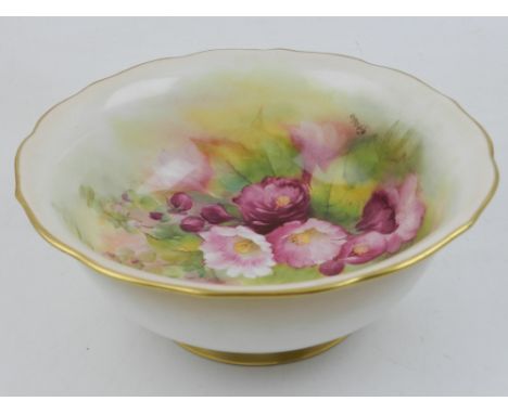 A Royal Worcester bowl, signed by Kitty Blake, the interior decorated with pink roses, having applied gilt rim and exterior. 