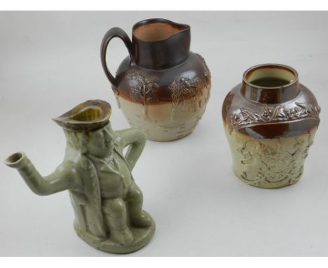 A Victorian salt glazed pottery jar applied Royal coat of arms together with a salt glazed harvest jug and a Toby teapot jug