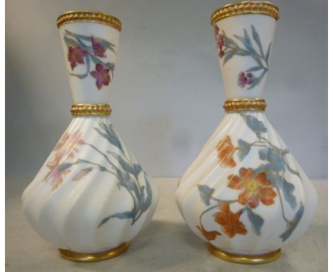 A pair of Royal Worcester blush ivory glazed porcelain, wrythen moulded and bulbous bottle vases, having long, flared necks a