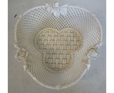 A First Period Belleek porcelain simulated woven and latticed cane basket of clover leaf form, encrusted with rose buds, flow