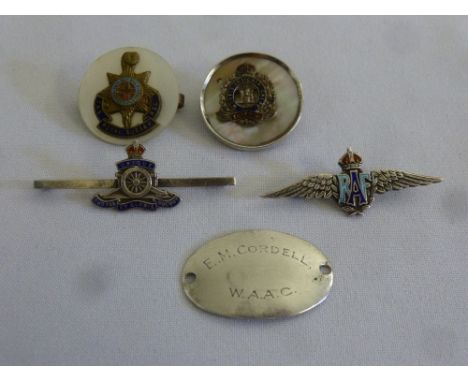 A quantity of military badges to include RAF silver and enamel wings, WAAG dog tag and three other badges